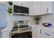 Close-up of stainless steel range and oven, with white cabinets and subway tile backsplash in a well-lit kitchen at 1215 E Cambridge Ave, Phoenix, AZ 85006