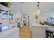 Kitchen view with white cabinets, stainless steel appliances, and a peninsula with breakfast bar in an open concept layout at 1215 E Cambridge Ave, Phoenix, AZ 85006