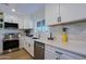 Updated kitchen featuring modern appliances, white cabinets, quartz countertops, and tile backsplash at 1215 E Cambridge Ave, Phoenix, AZ 85006