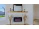 Close-up of a modern fireplace with a sleek black surround and decorative vases on either side at 1215 E Cambridge Ave, Phoenix, AZ 85006