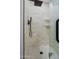 Shower with white tiled walls, black hardware, and glass door at 1215 E Cambridge Ave, Phoenix, AZ 85006