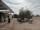 Outdoor patio with grill and seating area in backyard with mature landscaping and a covered patio at 12236 N Pebble Beach Dr, Sun City, AZ 85351