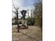 Landscaped yard with desert foliage featuring large cacti and gravel ground cover enclosed by a wrought iron fence at 12236 N Pebble Beach Dr, Sun City, AZ 85351