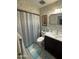 Neutral colored bathroom features a shower and tub combination and vanity with storage at 12236 N Pebble Beach Dr, Sun City, AZ 85351