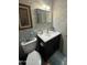 Bathroom includes a dark vanity cabinet, toilet and mirror above the sink at 12236 N Pebble Beach Dr, Sun City, AZ 85351