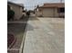 Wide concrete driveway leading to a single-car garage and gated side yard at 12236 N Pebble Beach Dr, Sun City, AZ 85351