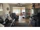 Cozy living room features a large leather sofa, a flat screen television and a view to the dining area at 12236 N Pebble Beach Dr, Sun City, AZ 85351