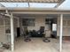 Covered outdoor patio featuring neutral decor with a large rug, seating, and side table at 12236 N Pebble Beach Dr, Sun City, AZ 85351