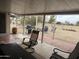 Outdoor covered patio area including a large table, comfortable seating, brick trim and access to backyard at 12236 N Pebble Beach Dr, Sun City, AZ 85351