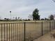 Backyard view of lush green golf course and neutral desert landscaping at 12236 N Pebble Beach Dr, Sun City, AZ 85351