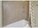 Tiled tub and shower combo with neutral tones and a shower curtain at 12326 N Lang Rd, Florence, AZ 85132