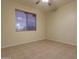 Inviting bedroom with tile floors, a ceiling fan, and a window offering plenty of natural light at 12326 N Lang Rd, Florence, AZ 85132