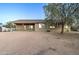 Exterior view of the home showcasing the covered porch and ample desert surroundings at 12326 N Lang Rd, Florence, AZ 85132