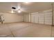 Spacious garage with two car doors, overhead lighting, and a ceiling fan at 12326 N Lang Rd, Florence, AZ 85132