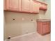 Laundry room with ample cabinet storage space and utility connections at 12326 N Lang Rd, Florence, AZ 85132