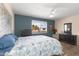 Cozy bedroom featuring wood floors, a ceiling fan, and ample natural light at 13207 N Lakeforest Dr, Sun City, AZ 85351