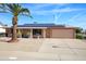 Charming single-story home featuring a well-maintained front yard with desert landscaping and solar panels at 13207 N Lakeforest Dr, Sun City, AZ 85351