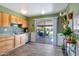 Inviting kitchen with wood cabinets, stainless steel appliances, and sliding glass door to the backyard at 13207 N Lakeforest Dr, Sun City, AZ 85351