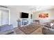 Bright living room features a ceiling fan, television above an electric fireplace, and comfortable seating at 13207 N Lakeforest Dr, Sun City, AZ 85351