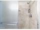 Modern shower with tiled walls, a rainfall showerhead, and a glass door at 13207 N Lakeforest Dr, Sun City, AZ 85351