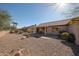 Large backyard with desert landscaping and a view of the home's patio at 15712 W Eucalyptus Ct, Surprise, AZ 85374