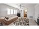 Bedroom with a soft rug, plantation shutters, and easy access to the bathroom at 15712 W Eucalyptus Ct, Surprise, AZ 85374