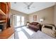 Comfortable bedroom with a ceiling fan, daybed, and sunlit French doors at 15712 W Eucalyptus Ct, Surprise, AZ 85374