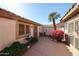 Charming courtyard with colorful flowers, lush greenery, and a tranquil fountain at 15712 W Eucalyptus Ct, Surprise, AZ 85374