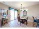 Charming dining area with elegant chandelier, table, and chairs near sliding glass doors for natural light at 15712 W Eucalyptus Ct, Surprise, AZ 85374