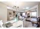 Open-concept dining room with a glass table and views into the living room and kitchen at 15712 W Eucalyptus Ct, Surprise, AZ 85374