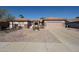 Charming single-story home features a two-car garage, gravel landscaping, and a covered entryway at 15712 W Eucalyptus Ct, Surprise, AZ 85374