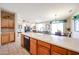 Spacious kitchen with wood cabinets, a large sink, and views into the dining and living areas at 15712 W Eucalyptus Ct, Surprise, AZ 85374