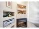 Close up view of the fireplace with surrounding built-in shelving in the living room at 15712 W Eucalyptus Ct, Surprise, AZ 85374