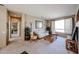 Cozy living room with neutral tones, plush carpet, and a view into the Primary bedroom hallway at 15712 W Eucalyptus Ct, Surprise, AZ 85374