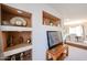 Built-in shelving provides ample display space in this open-concept room with views into the dining room at 15712 W Eucalyptus Ct, Surprise, AZ 85374