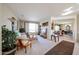 Bright and airy living room featuring plush carpeting and an open floor plan to the dining area at 15712 W Eucalyptus Ct, Surprise, AZ 85374