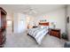 Bright main bedroom with plush carpet, ceiling fan, and updated furniture at 15712 W Eucalyptus Ct, Surprise, AZ 85374