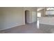 Open living space showcasing a seamless transition from carpeted living room to tiled kitchen and dining area at 15971 N 91St Dr, Peoria, AZ 85382