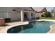 The sparkling pool is surrounded by patio and shaded by a covered porch at 15971 N 91St Dr, Peoria, AZ 85382