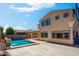 Backyard showcasing a large pool with basketball court and desert landscaping at 16074 W Cortez St, Surprise, AZ 85379