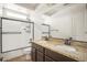 Bathroom featuring double sinks and a shower-tub combo at 16074 W Cortez St, Surprise, AZ 85379