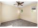 Bedroom featuring neutral carpet, ceiling fan, and a large window at 16074 W Cortez St, Surprise, AZ 85379