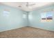 Light-filled bedroom with three windows and a ceiling fan at 16074 W Cortez St, Surprise, AZ 85379