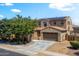 Two-story home with a two-car garage and well-manicured landscaping at 16074 W Cortez St, Surprise, AZ 85379