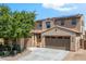 Charming two-story home with a two car garage, desert landscaping, and a cozy front porch at 16074 W Cortez St, Surprise, AZ 85379