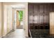 Stylish kitchen featuring dark cabinets and an open doorway at 16074 W Cortez St, Surprise, AZ 85379