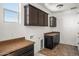 Well-lit laundry room with cabinets and countertops at 16074 W Cortez St, Surprise, AZ 85379