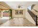 Bright living room featuring tile flooring and a staircase leading to the upper level at 16074 W Cortez St, Surprise, AZ 85379