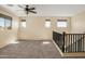 Upstairs loft featuring neutral carpet, lots of natural light and railing at 16074 W Cortez St, Surprise, AZ 85379