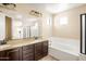 Elegant primary bathroom featuring a double vanity, soaking tub, and neutral color palette at 16074 W Cortez St, Surprise, AZ 85379